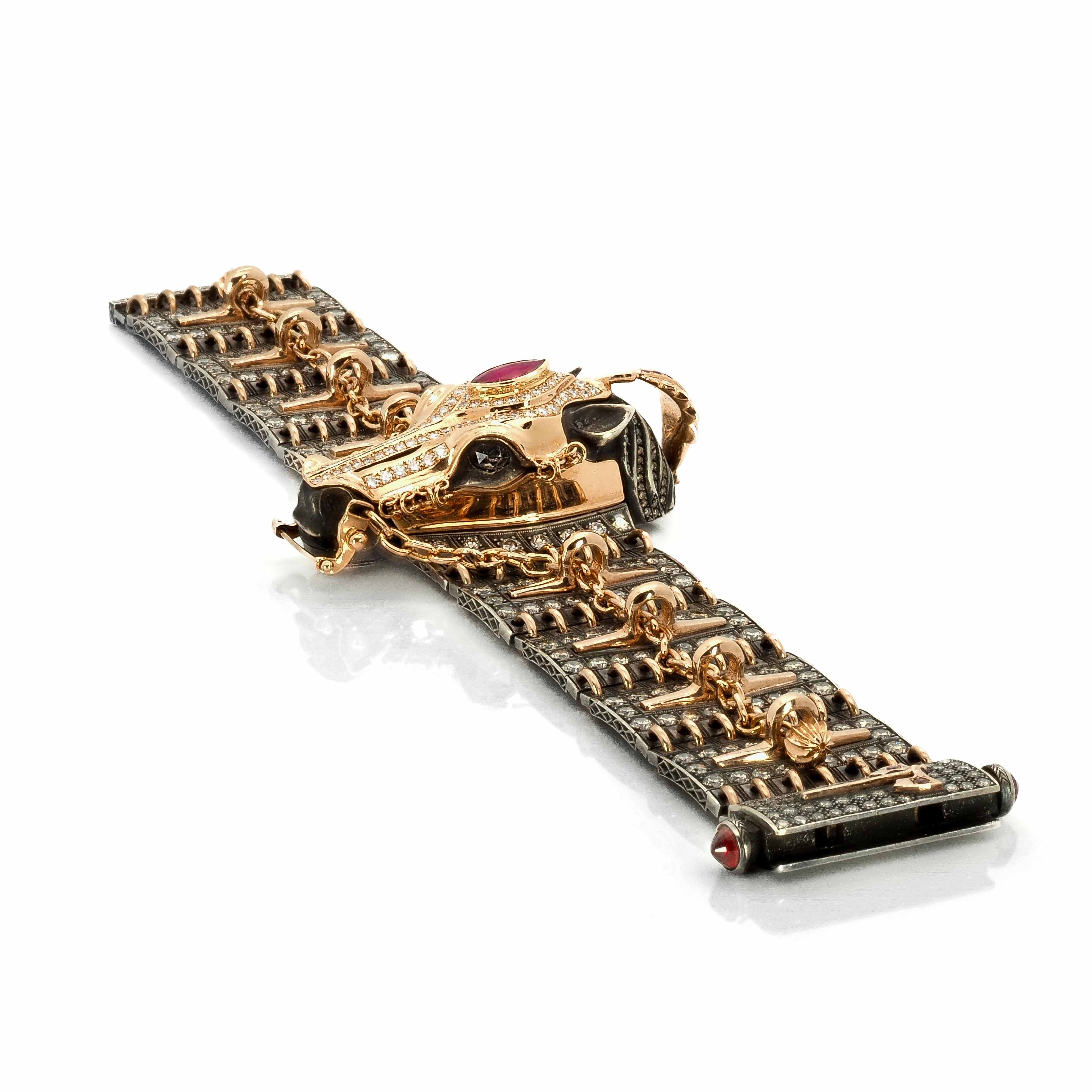 Taru Jewelry Ceremonial Horse Bracelet showcases a beautifully handcrafted horse made of sterling silver with an 18K rose gold medieval chamfron, an armor worn by horses in medieval times. The chamfron is adorned with sparkling white diamonds and a central ruby gem.