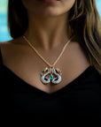 Taru Jewelry Dragon Necklace is an elegant piece crafted from 18K rose gold and sterling silver. Featuring a majestic design of two dragons, it is adorned with sparkling white antique rosecut diamonds and champagne diamonds.