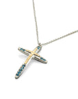Taru Jewelry Cross Necklace made of 18K yellow gold and sterling silver is a beautiful combination of traditional symbolism and modern design. The cross, a timeless symbol of faith and devotion, is adorned with sparkling blue topaz, adding a touch of color and elegance to the piece.