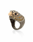 Taru Jewelry Falcon Ring is crafted from 18K rose gold, sterling silver, and featuring a stunning array of yellow sapphires and rosecut diamonds. The falcon is known for its sharp and piercing gaze, and this is perfectly captured in the design of this ring.