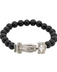 The Race Car Black Onyx Bracelet is a stylish and sleek piece of jewelry that is perfect for those who love cars or racing. It is made from black onyx beads and features a small silver race car charm. The bracelet is stretchy and comfortable to wear, and can fit most wrist sizes. The black onyx beads are said to have protective energy and are believed to help with stress and anxiety. This bracelet is a great accessory for any car enthusiast or anyone who loves unique and trendy jewelry.