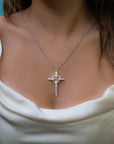 Taru Jewelry Cross and Heart Necklace crafted from 18K gold and silver is a unique blend of traditional and modern design. The cross, a timeless symbol of faith and devotion, is adorned with beautiful pink topaz, adding a touch of color and elegance to the piece.
