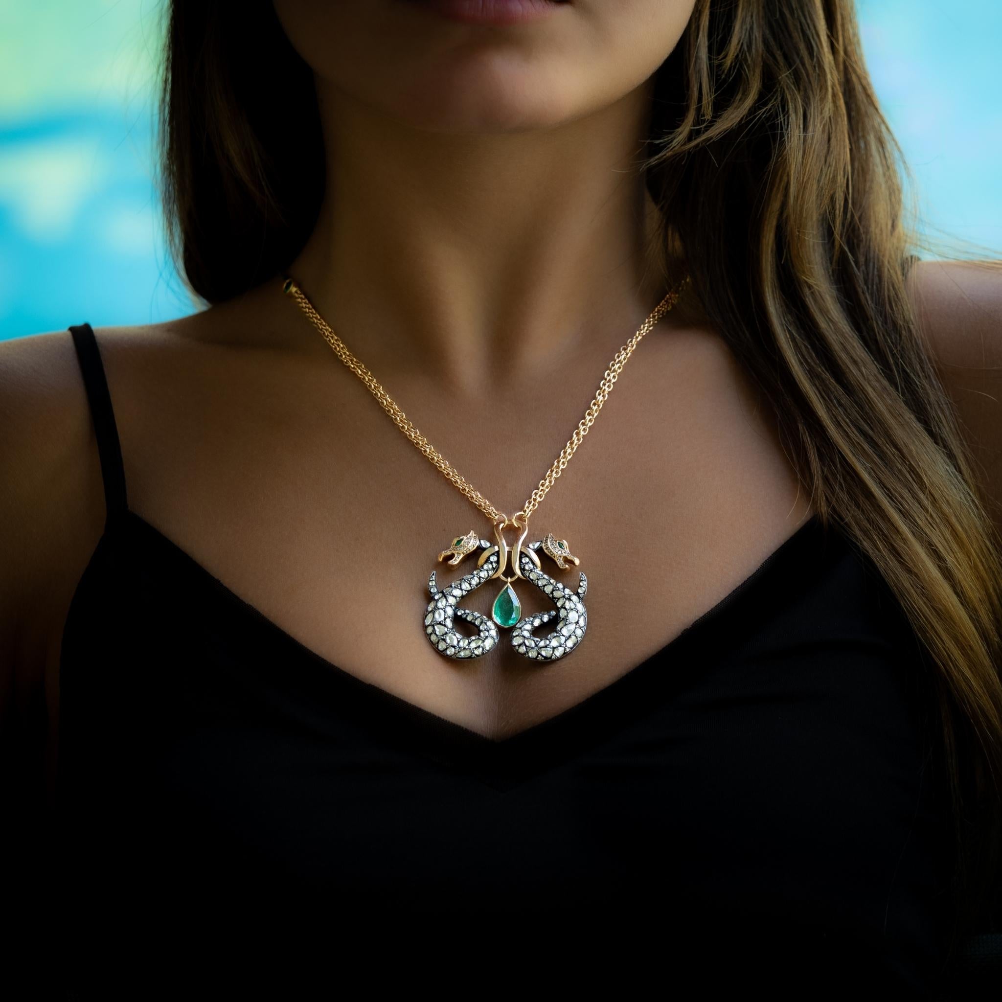 Taru Jewelry Dragon Necklace is an elegant piece crafted from 18K rose gold and sterling silver. Featuring a majestic design of two dragons, it is adorned with sparkling white antique rosecut diamonds and champagne diamonds.