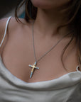 Taru Jewelry Cross Necklace made of 18K yellow gold and sterling silver is a beautiful combination of traditional symbolism and modern design. The cross, a timeless symbol of faith and devotion, is adorned with sparkling blue topaz, adding a touch of color and elegance to the piece.