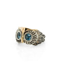 Taru Jewelry charming owl ring is a unique piece crafted from 18K gold and sterling silver, featuring a design that captures the essence of the wise and mysterious bird. The owl is a symbol of wisdom, known for its sharp vision and hearing. It is also believed to be a protector and messenger of secrets. The ring features London blue topaz as the owl's eyes, which represents loyalty and righteousness, and brown diamonds for the feathers. It is said to help improve communication and finding success.