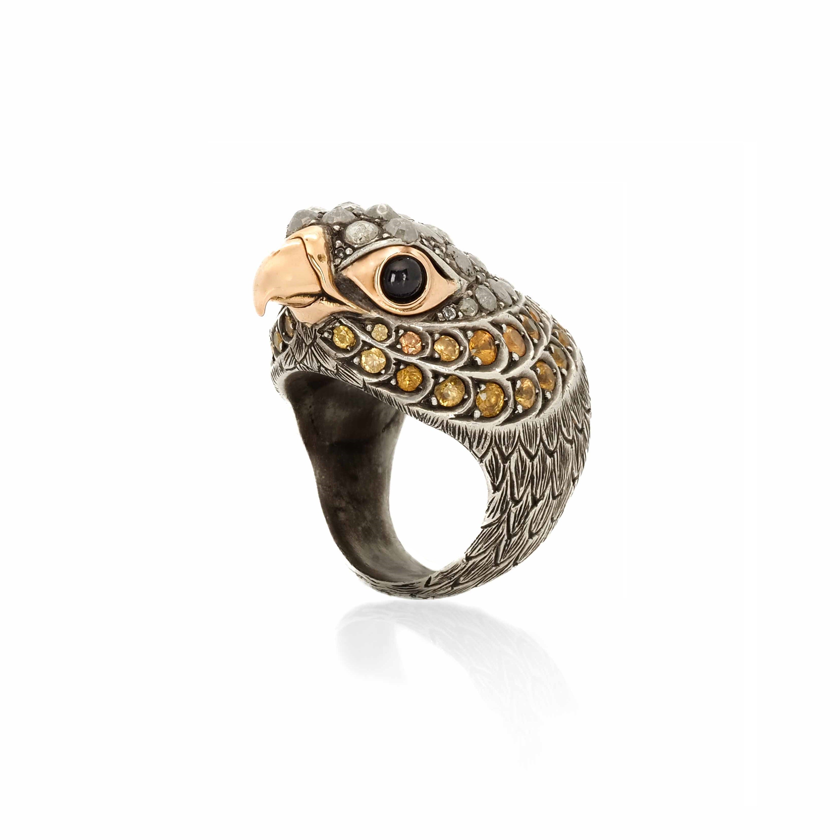 Taru Jewelry Falcon Ring is crafted from 18K rose gold, sterling silver, and featuring a stunning array of yellow sapphires and rosecut diamonds. The falcon is known for its sharp and piercing gaze, and this is perfectly captured in the design of this ring. 